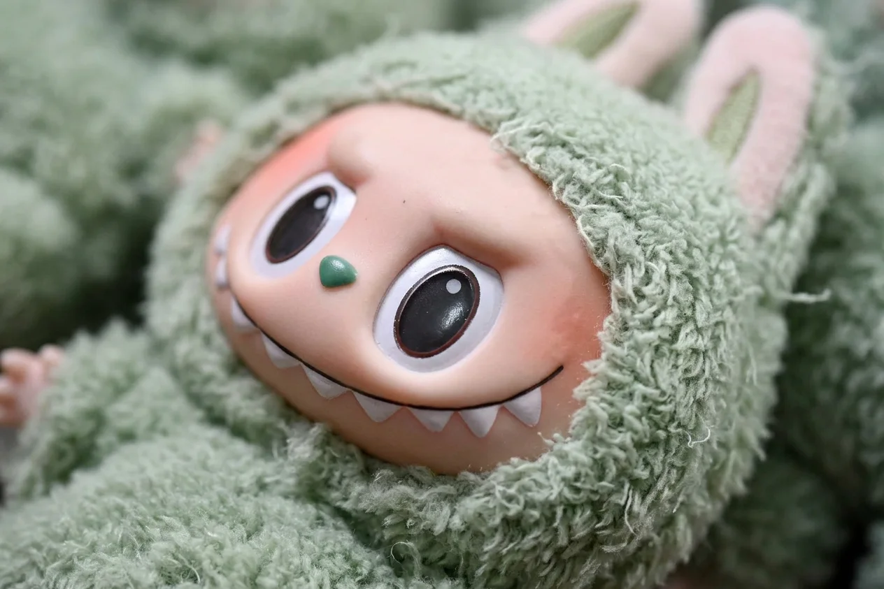 Close up macro photography of soft furry plush texture and a mischievous toothy smile of a designer toy